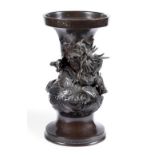 A Japanese bronze vase cast with a dragon amongst clouds, the base inscribed with a four character