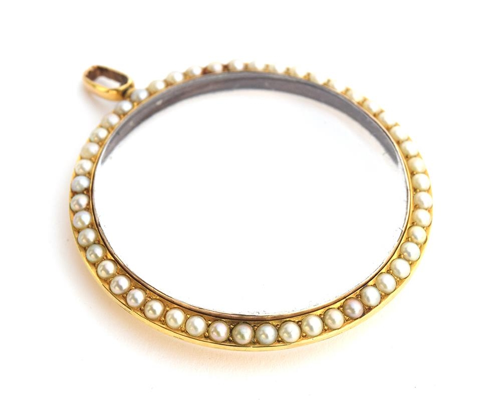 A yellow metal and split pearl double sided photo locket, 5cm diameter