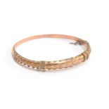 An Edwardian 9ct gold hollow bangle with ropetwist and cannetille decoration, hallmarked for J.S,