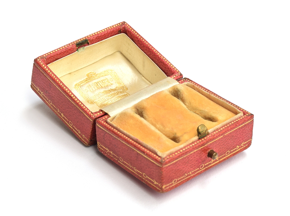 An early 20th century Cartier double ring box, red leather and gilt tooled exterior, with peach