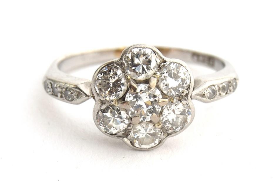 An Edwardian platinum and diamond floral cluster ring, six diamonds surrounding a central diamond,