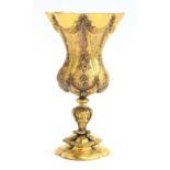 A late 19th century Italian gilt copper chalice, with floral swag pattern with trefoil form foot,