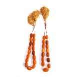 Two butterscotch amber graduated bead necklaces, one necklace 17 beads, the other 15, the largest