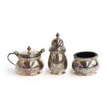 A three piece silver cruet set by Adie Brothers Ltd, Birmingham 1960, with Celtic band decoration,