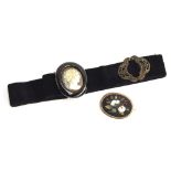 A Victorian pietra dura brooch mounted in gold, 5x4cm; together with a black velvet belt, set with a