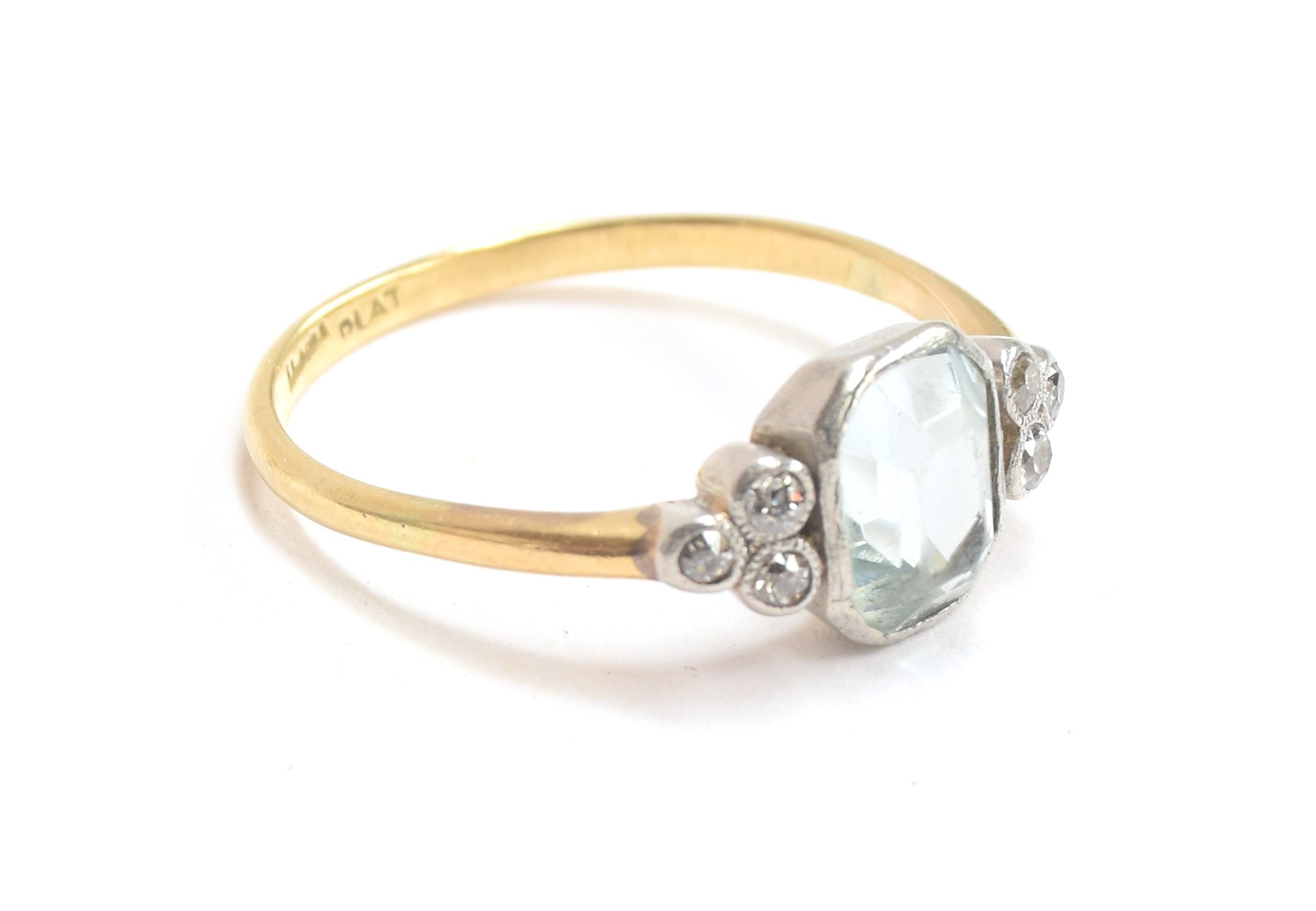 An 18ct gold and platinum ring set with a large emerald cut aquamarine between two trefoils of old - Image 2 of 2