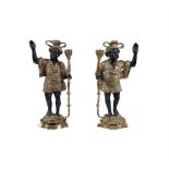 A pair of brass and patinated models of 'Blackamoors', early 20th century, as candlesticks, 39cm