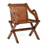 A golden oak Glastonbury chair, with applied Gothic detail to back, 69cm wide