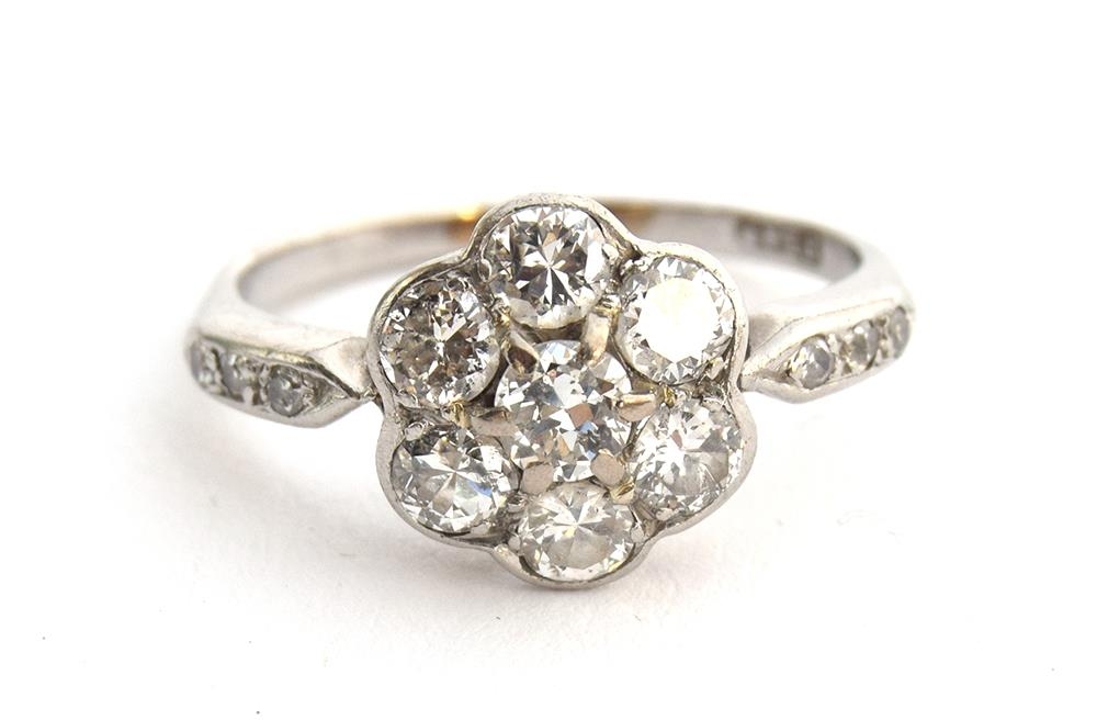 An Edwardian platinum and diamond floral cluster ring, six diamonds surrounding a central diamond, - Image 2 of 5