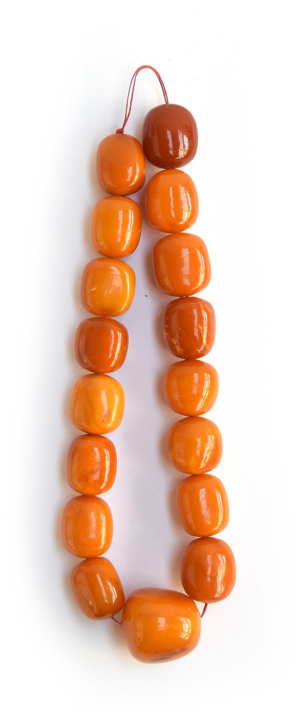 A heavy butterscotch amber bead necklace, the largest of the 17 beads approx. 3.5x3.5cm, approx.