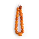 A heavy butterscotch amber bead necklace, the largest of the 17 beads approx. 3.5x3.5cm, approx.