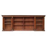 A Regency mahogany break front bookcase, comprising four sections, with gadrooned pediment, the