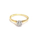 An 18ct gold and diamond solitaire ring, with platinum claws, the diamond approx. 0.65cts,