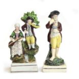 Two 19th century Staffordshire pearlware figures, a barefooted man holding grapes and a wine