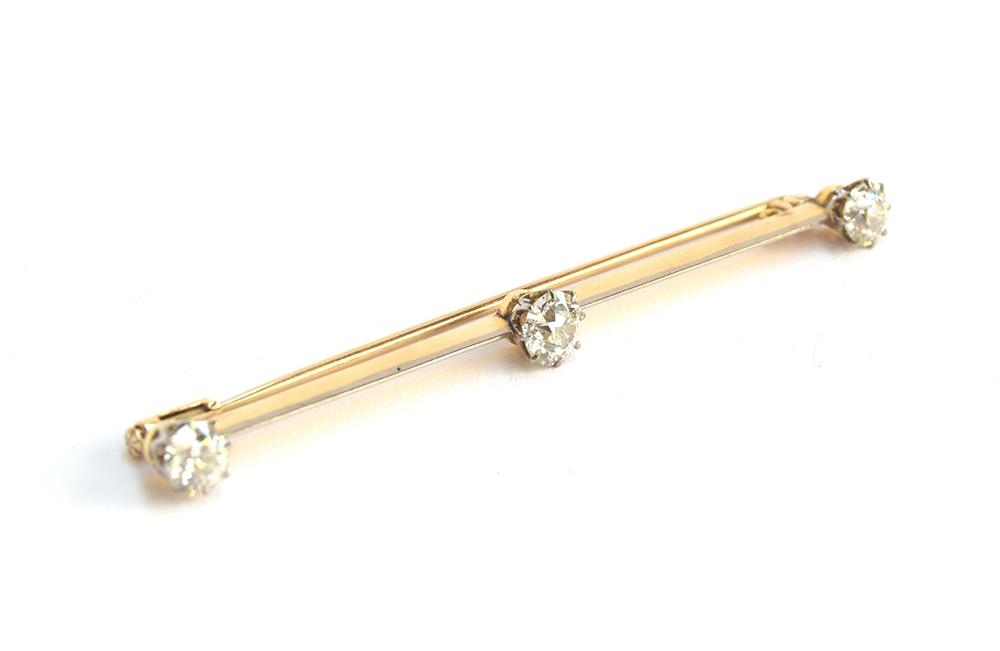 An early 20th century gold and old brilliant cut diamond set knife edge bar brooch, tests as at