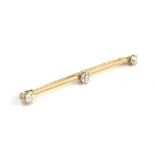 An early 20th century gold and old brilliant cut diamond set knife edge bar brooch, tests as at