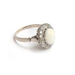 A diamond and opal cabochon ring mounted in white metal, size W, approx. 7g