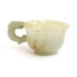 A Chinese celadon and russet jade libation cup, the handle in the form of a dragon, 4cm high