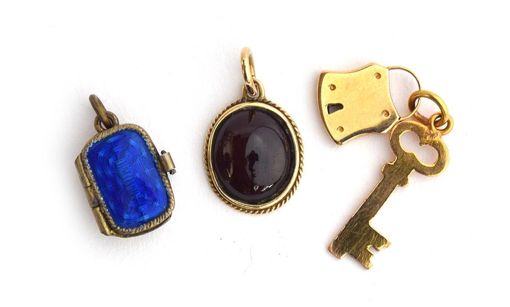 A 14ct gold pendant set with a garnet cabochon, 1.4cm long; together with a yellow metal padlock and