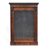 A Regency rosewood pier cabinet, the marble top over glazed door, flanked by lotus capped fluted