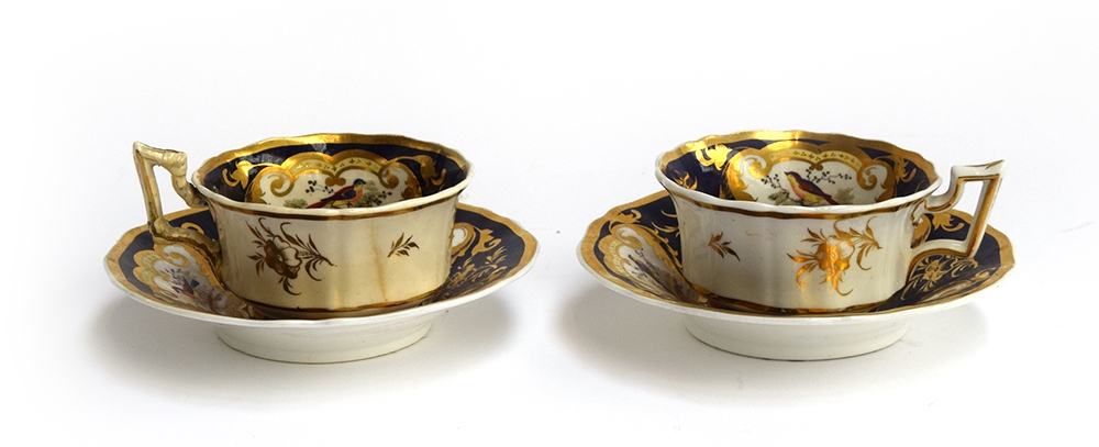 A pair of 19th century Grainger teacups and saucers c.1830, Royal Flute shape, panels of floral