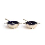 A pair of salts by the Adie Brothers Ltd, Birmingham 1924, in the form of twin handled porringers,
