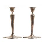 A pair of loaded silver candlesticks by William Hutton & Sons Ltd, Sheffield 1913, on slender oval