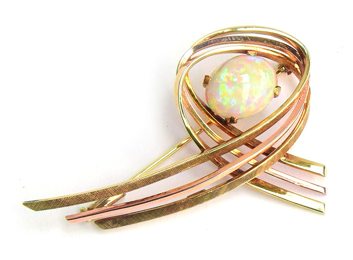 A 14ct gold modernist brooch set with a large opal cabochon, approx. 7.4g, 5cm wide