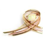 A 14ct gold modernist brooch set with a large opal cabochon, approx. 7.4g, 5cm wide