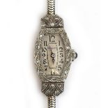 A ladies Art Deco 9ct white gold and diamond set cocktail watch, with oblong silvered dial