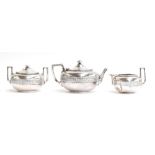 A three piece .925 silver tea set by Tiffany & Co, 550 Broadway, of compressed oval form, the teapot