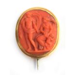 A Georgian carved coral cameo brooch, depicting a classical scene, mounted in gold, tests as 14ct or