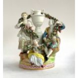 A late 19th century Meissen figure group depicting a pair of lovers holding an encrusted floral