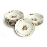 A set of fourteen 19th century porcelain bowls, hand painted with floral sprays, the rims heightened