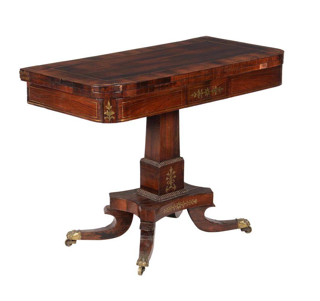 A George IV rosewood and brass inlaid card table, c.1825, the folding top enclosing a baize