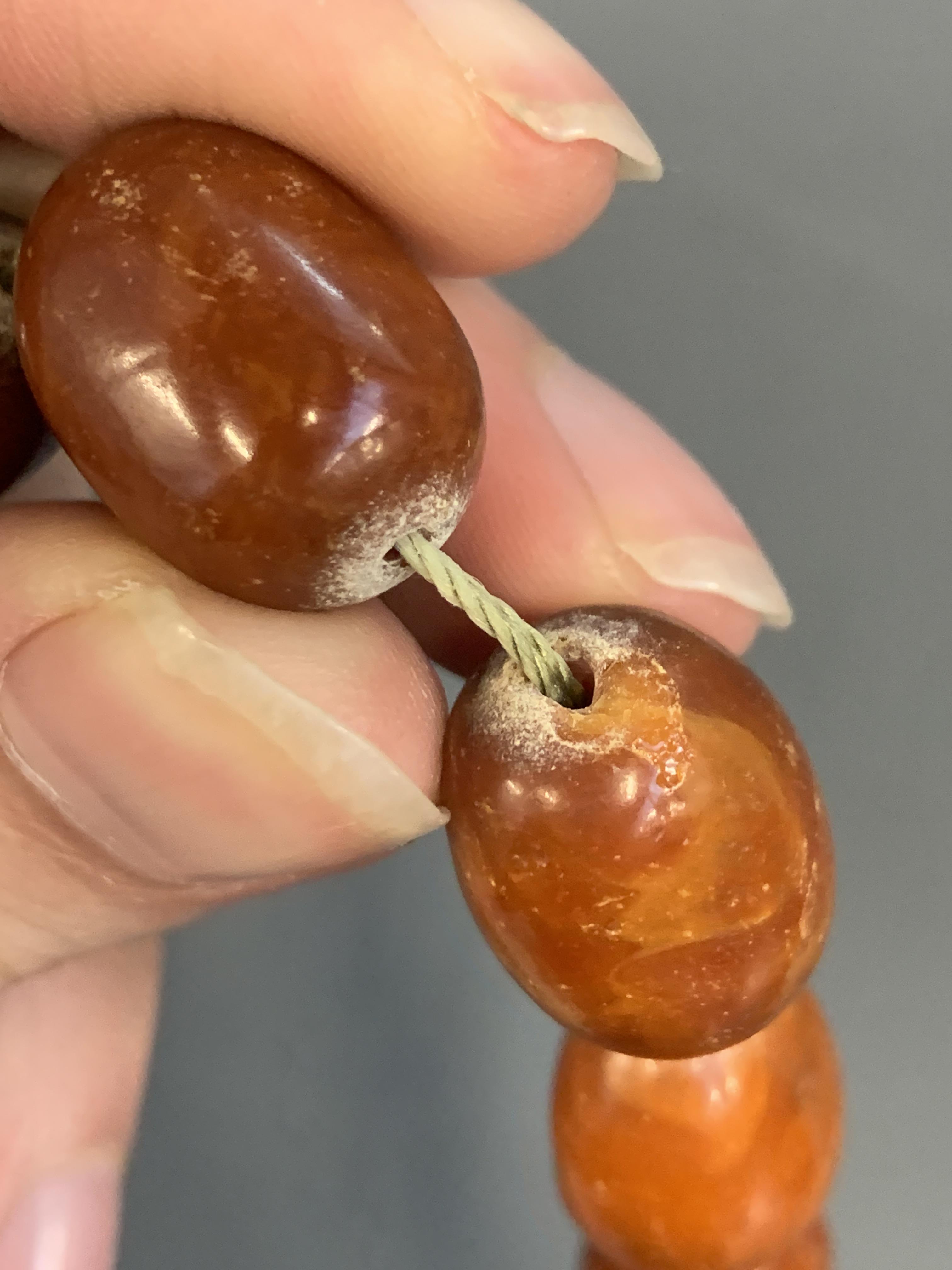 A graduated cognac amber bead necklace, approx. 59g, 57cm long - Image 3 of 4