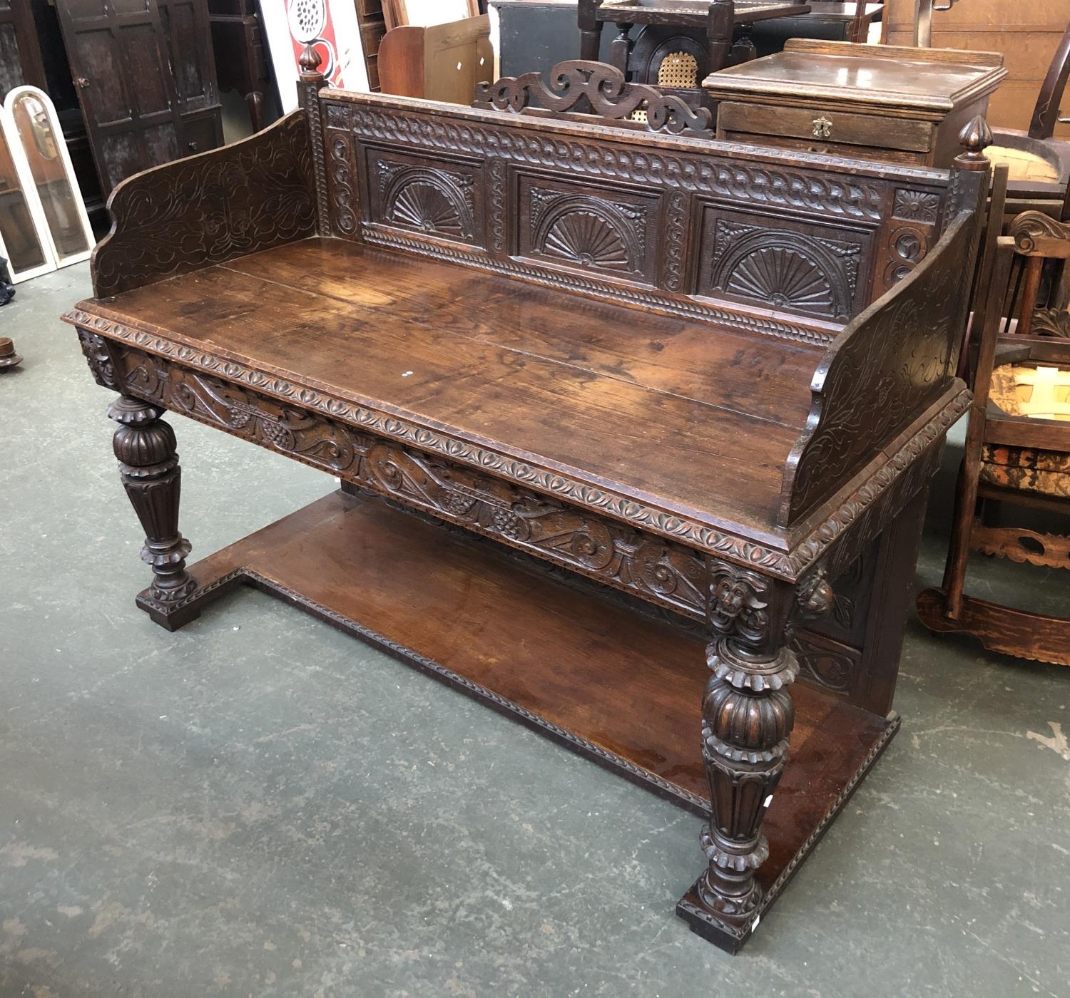 A Victorian oak side table, profusely carved gallery, the top with egg and dart moulding over a