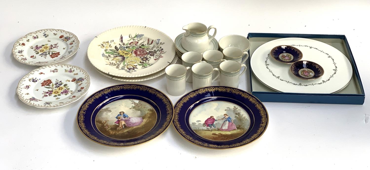 A pair of Sevres hand painted cobalt cabinet plates, depicting Continental courting couples, each