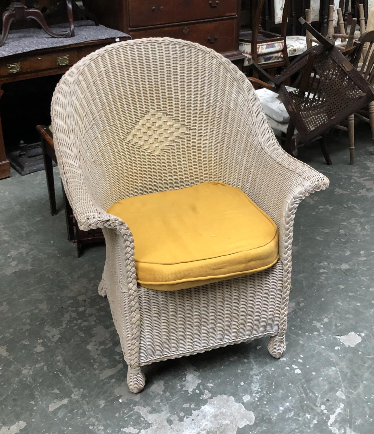 A wicker conservatory chair with yellow cushion