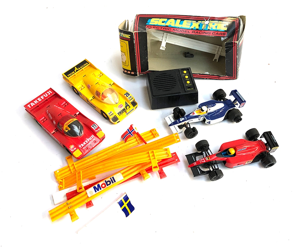 Four Scalextric cars to include Takefuji porsche, one other Porsche and two F1 cars, together with