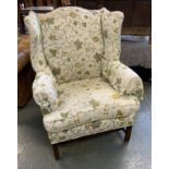 A George III style wingback armchair, on moulded legs and H stretcher, 82cmW