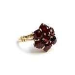 An early 20th century 9ct gold floral garnet cluster ring, size I 1/2, approx. 4g