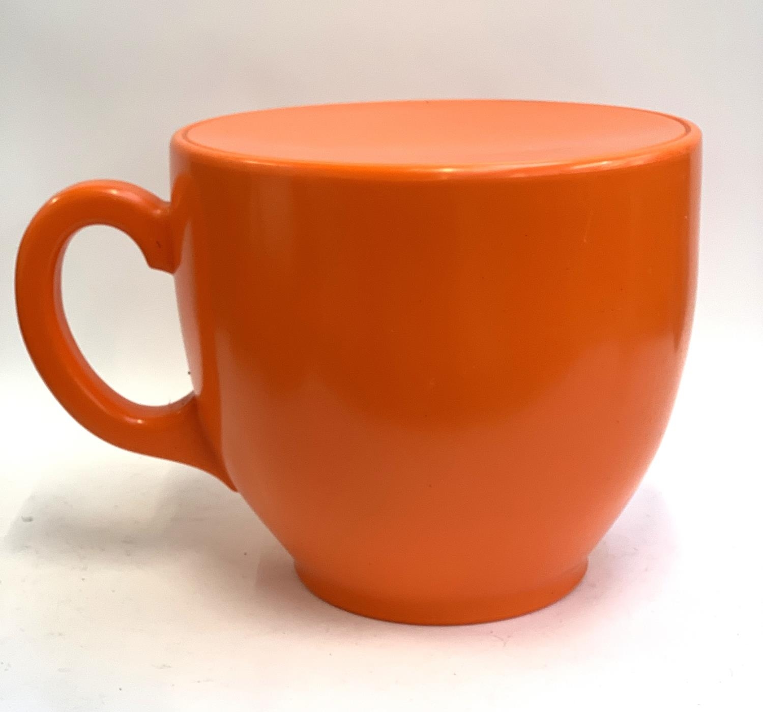 A novelty orange plastic oversized teacup stool, 40cmH