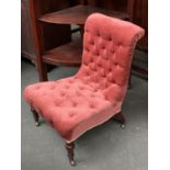 A Victorian button back bedroom chair by C. Hindley & Sons, with turned legs and casters, stamped to