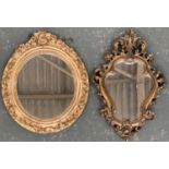 Two gilt framed wall mirrors, one with shaped plate, 50x34cm, the other oval with floral surround,