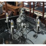 A modern five arm chandelier, 46cmW; together with a glass candle stand, 32cmH