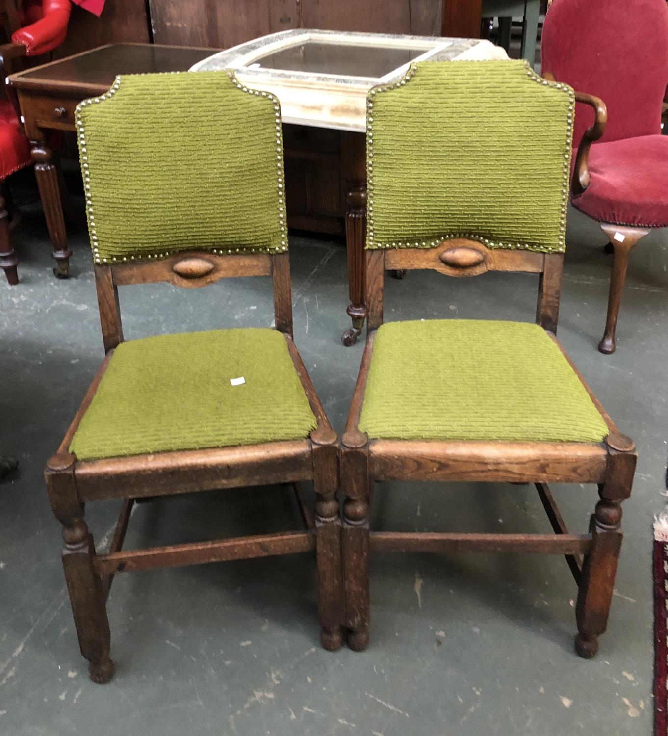 A pair of oak side chairs upholstered in green fabric