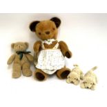 A large vintage teddy bear in a dress, 67cmH, together with 2 Andrex puppies and a Teddy-Hermann