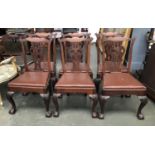 A set of six 19th century Chippendale style splatback dining chairs, on acanthus capped cabriole