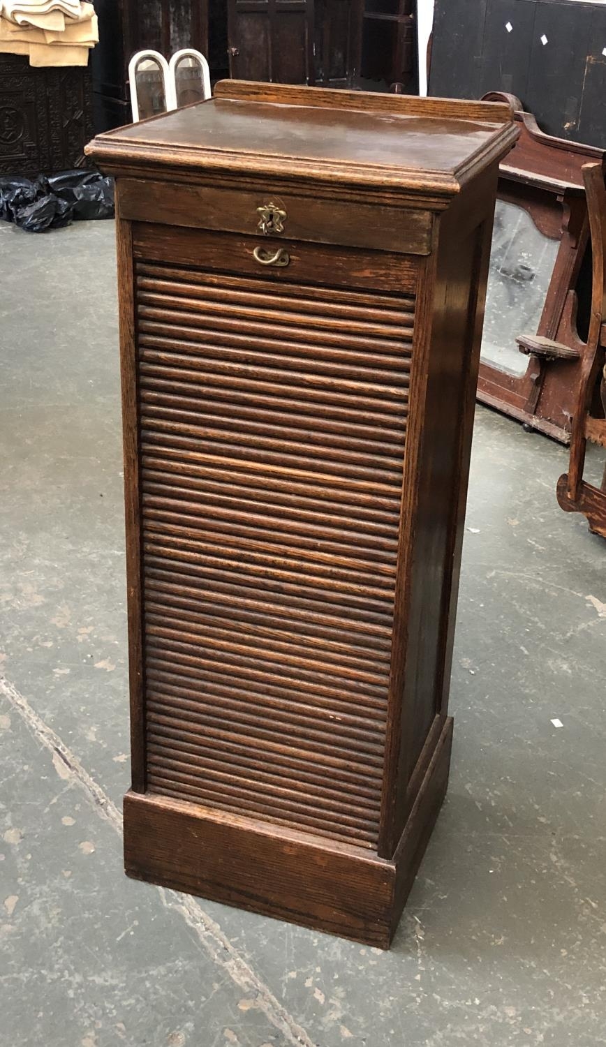 A 20th century oak tambour fronted filing cabinet, with slides, 47x42x117cmH